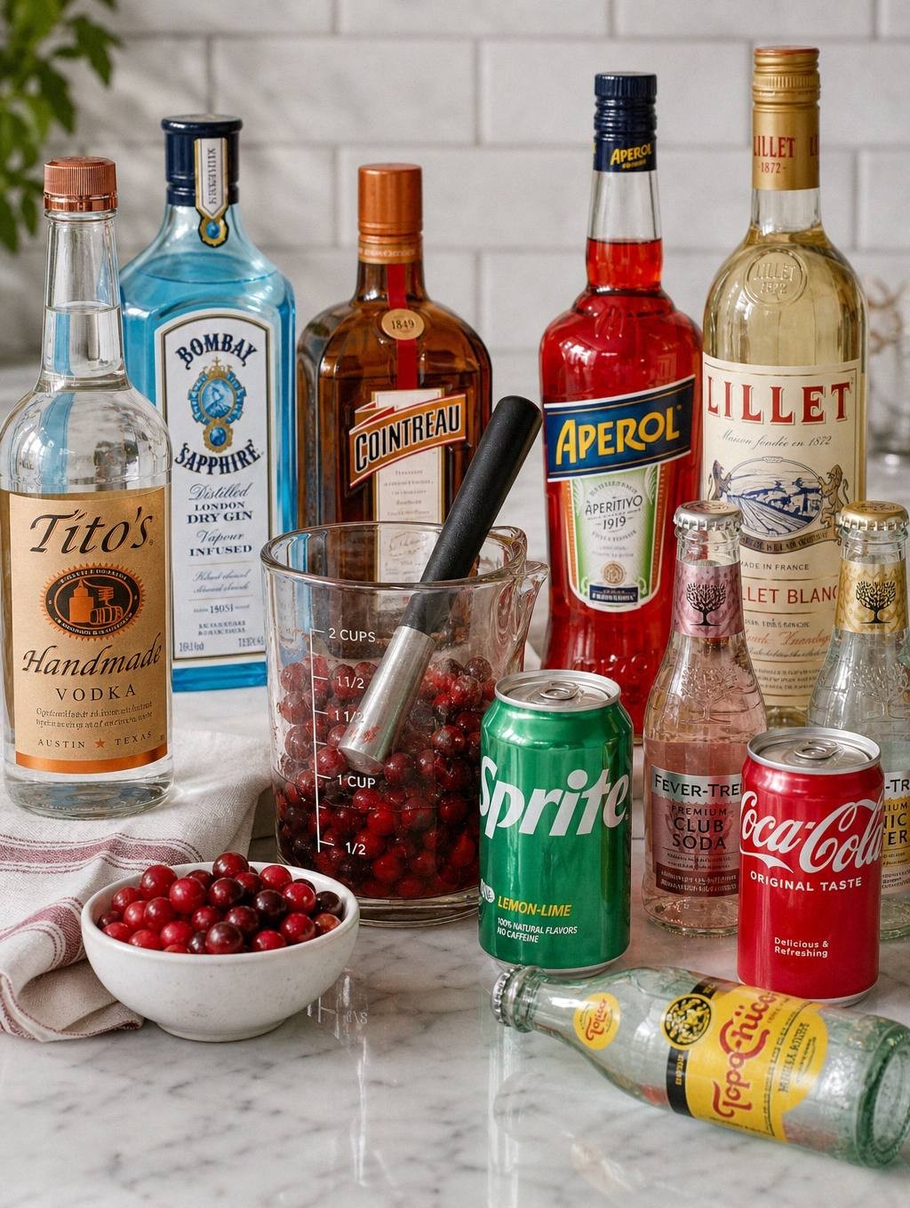 Measured ingredients for cranberry vodka including fresh cranberries, honey, vodka, lime wedges, and sparkling water